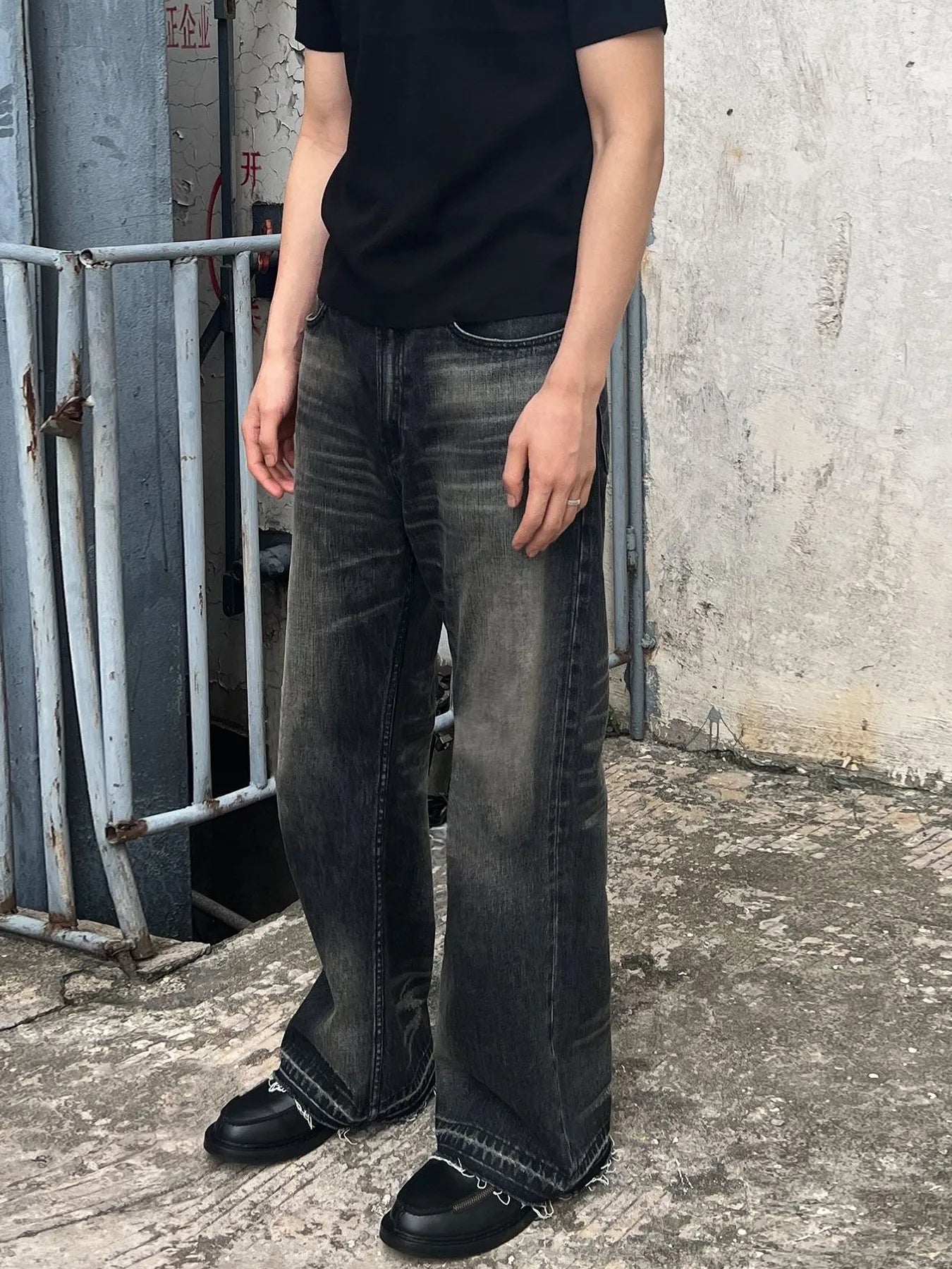 Men's vintage washed frayed hem jeans, trendy denim bottoms with distressed details, by Trendsi, shown on a model.