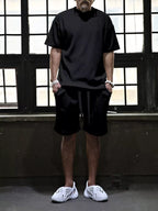 Men's plus size short sleeve top and shorts set by Trendsi, featuring a coordinated casual outfit in comfortable fabric.