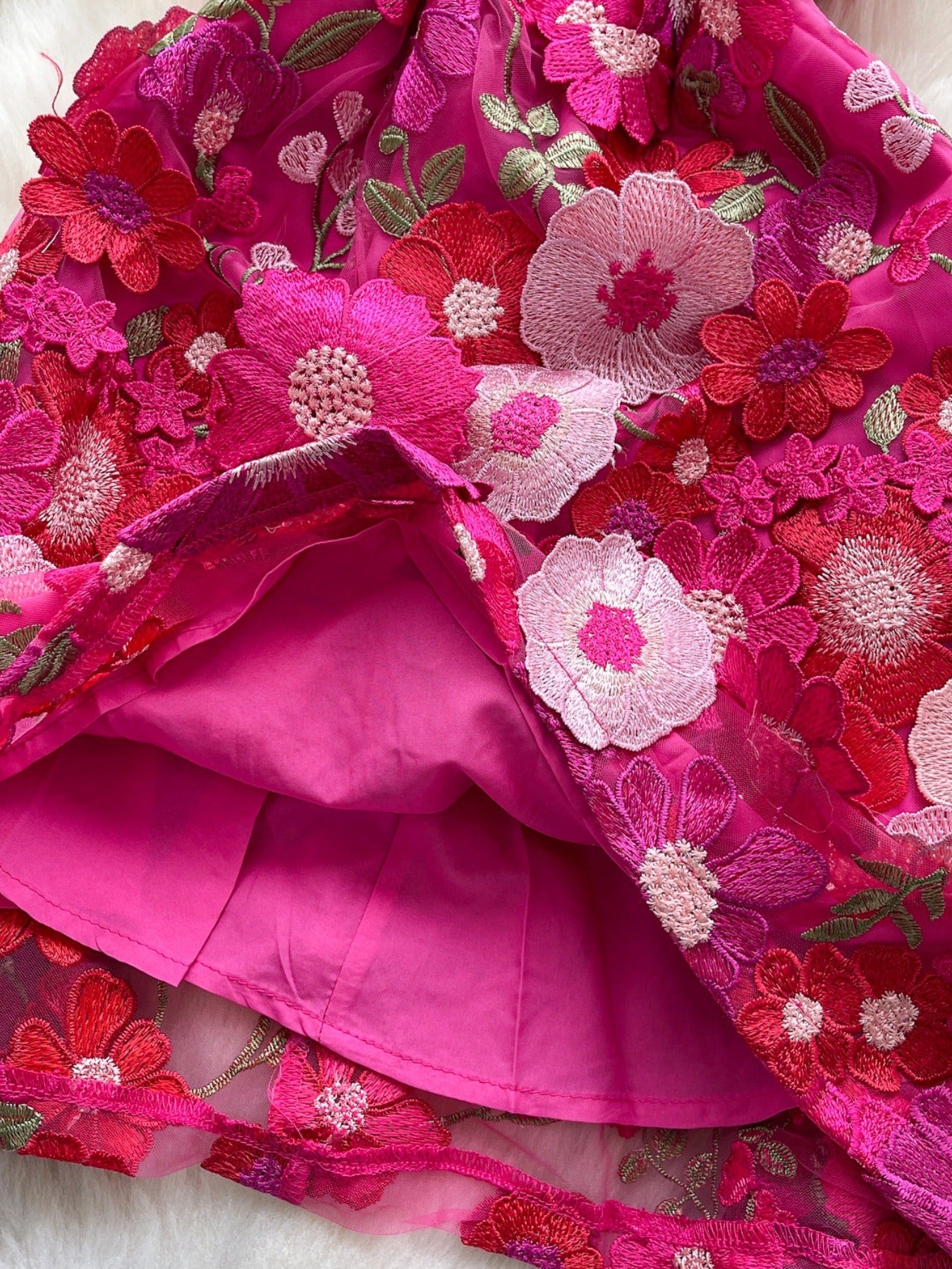 Floral embroidered tie waist mini dress by Trendsi featuring an elegant summer A-line silhouette and colorful floral embroidery.