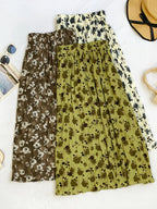 Floral print elastic waist midi skirt from Trendsi, featuring a flowy design and vibrant floral pattern, perfect for casual or dressy wear.