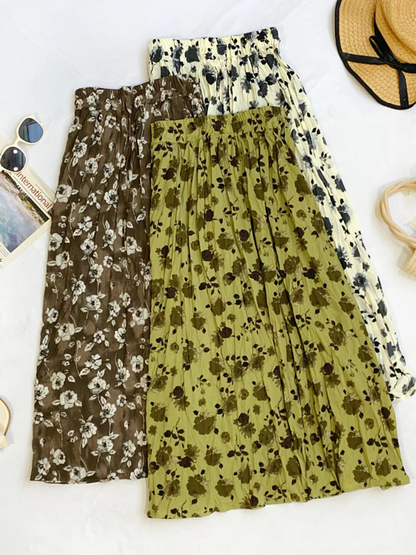 Floral print elastic waist midi skirt from Trendsi, featuring a flowy design and vibrant floral pattern, perfect for casual or dressy wear.