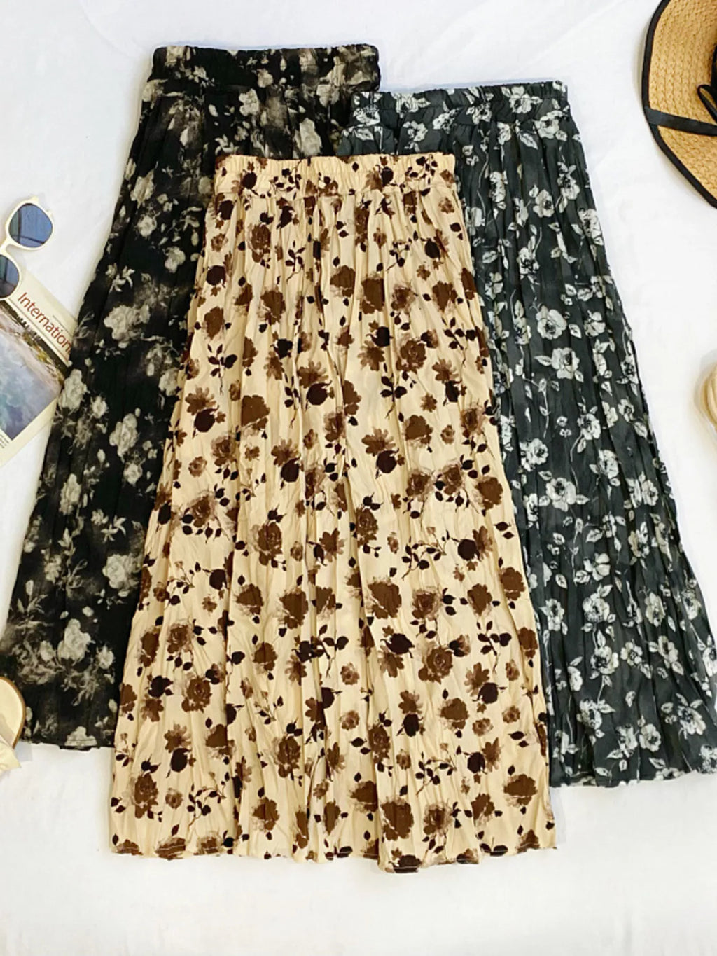Floral print elastic waist midi skirt from Trendsi, showcasing a flowy design with vibrant flower patterns and a comfortable fit.