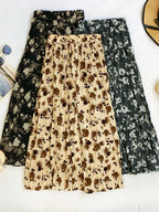 Floral print elastic waist midi skirt from Trendsi, showcasing a flowy design with vibrant flower patterns and a comfortable fit.