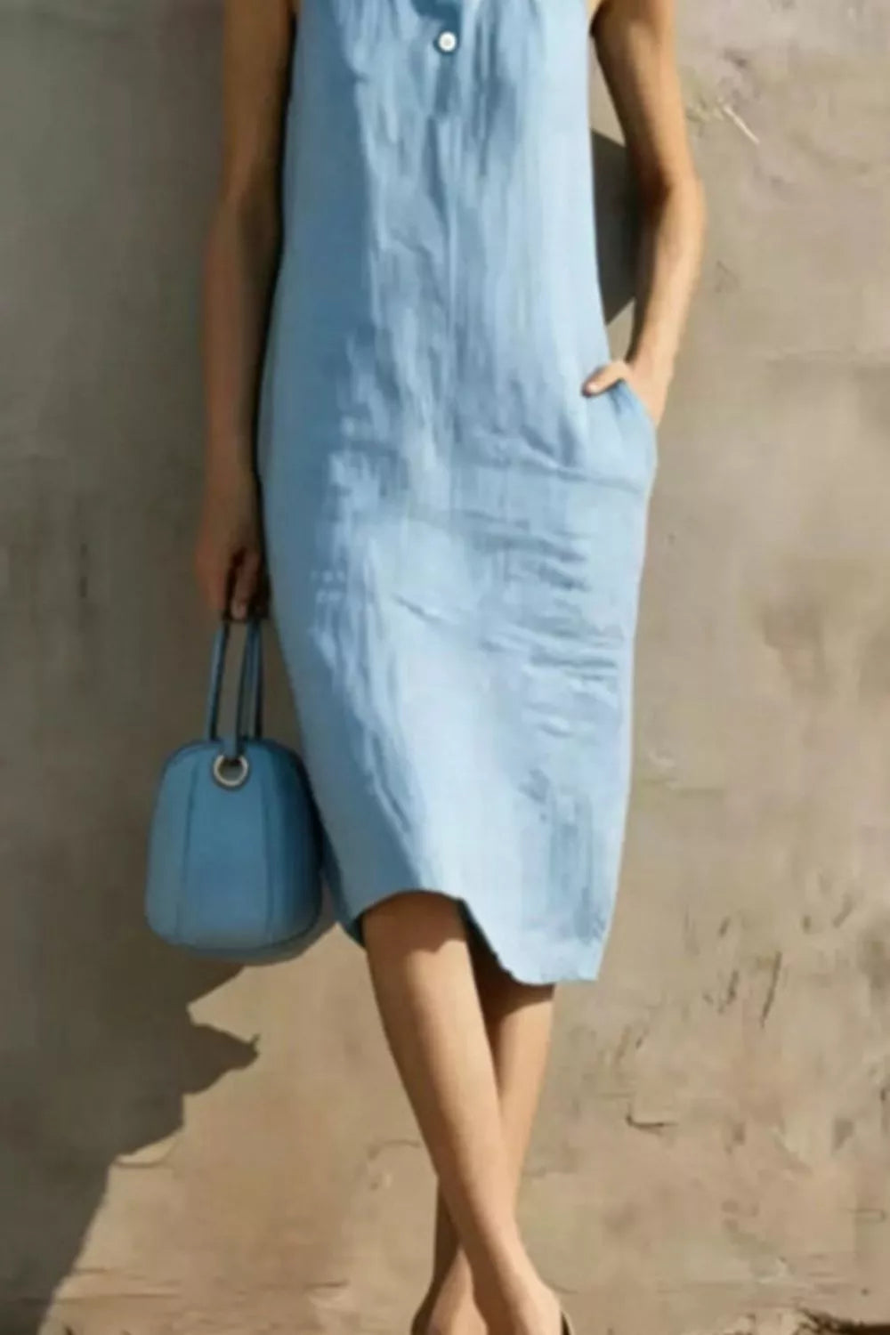 Casual sleeveless midi dress with button details in soft fabric, perfect for stylish summer or spring wear.