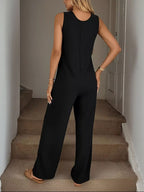 Sleeveless button-front wide-leg jumpsuit by Trendsi featuring a comfortable, chic design and relaxed fit in a stylish romper style.