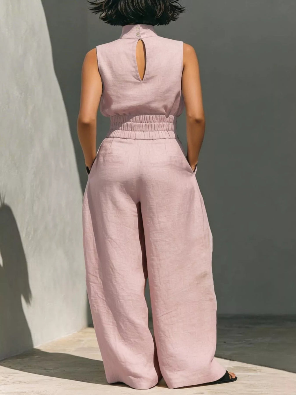 Sleeveless turtleneck top and wide-leg pants set by Trendsi, featuring a stylish, coordinated fashion look.
