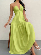 Lime green halter-neck maxi dress with a gathered bodice and tiered, flowing skirt.
