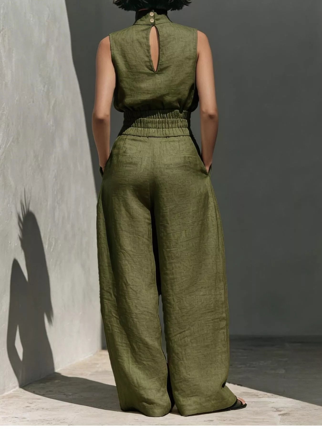 Sleeveless turtleneck top and wide-leg pants set by Trendsi, featuring a stylish, coordinated outfit with neutral tones.