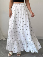 Trendsi bowknot print ruffle hem maxi skirt with flowing fabric and waist tie, showcasing a stylish, feminine design.