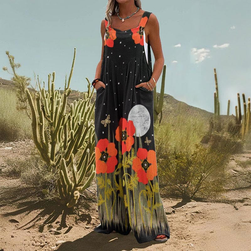 Black wide-leg jumpsuit with orange poppy flowers, moon, star pattern, and deep side pockets.
