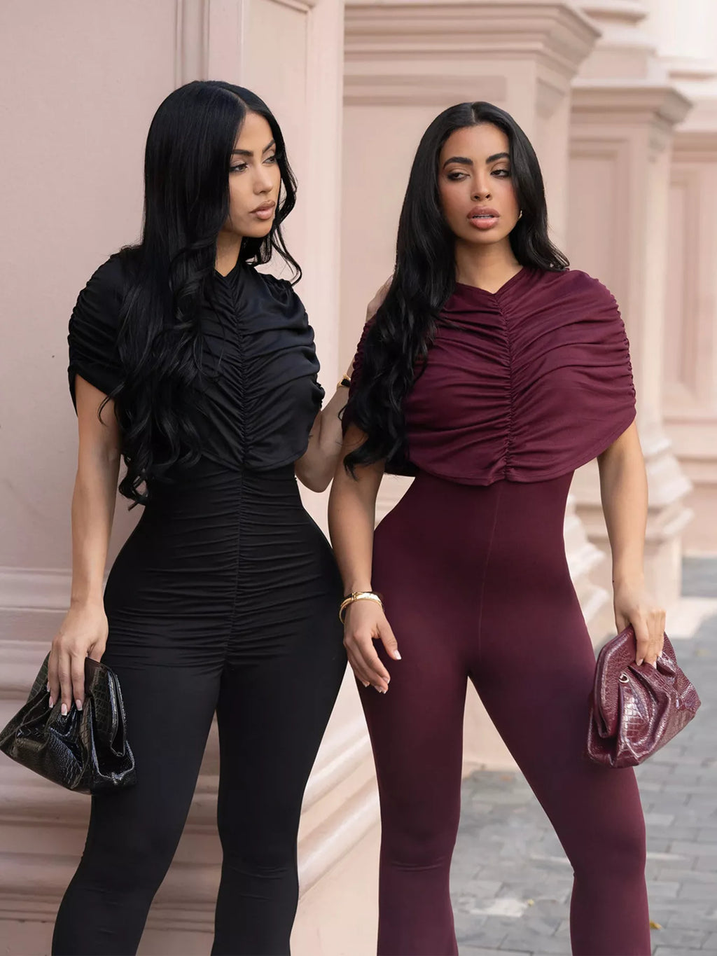 Black ruched flare leg jumpsuit from Trendsi with a fitted bodice and wide flare pants, perfect for stylish casual wear.
