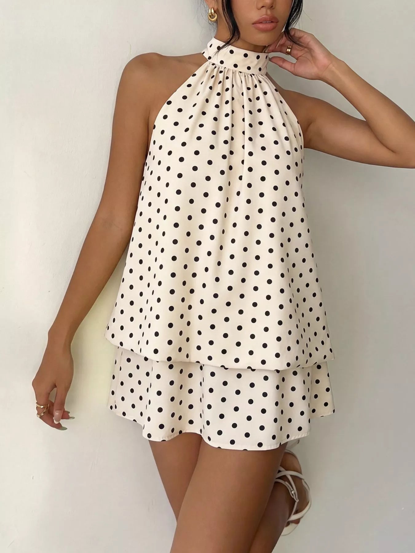 Polka dot halter neck mini dress by Trendsi featuring a fitted bodice and flared skirt, perfect for summer or casual occasions.