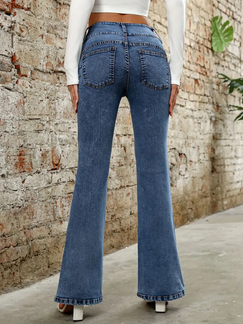 Plush Fashion Shop denim bootcut jeans with classic pockets, showcasing a fitted waist and flared leg design.