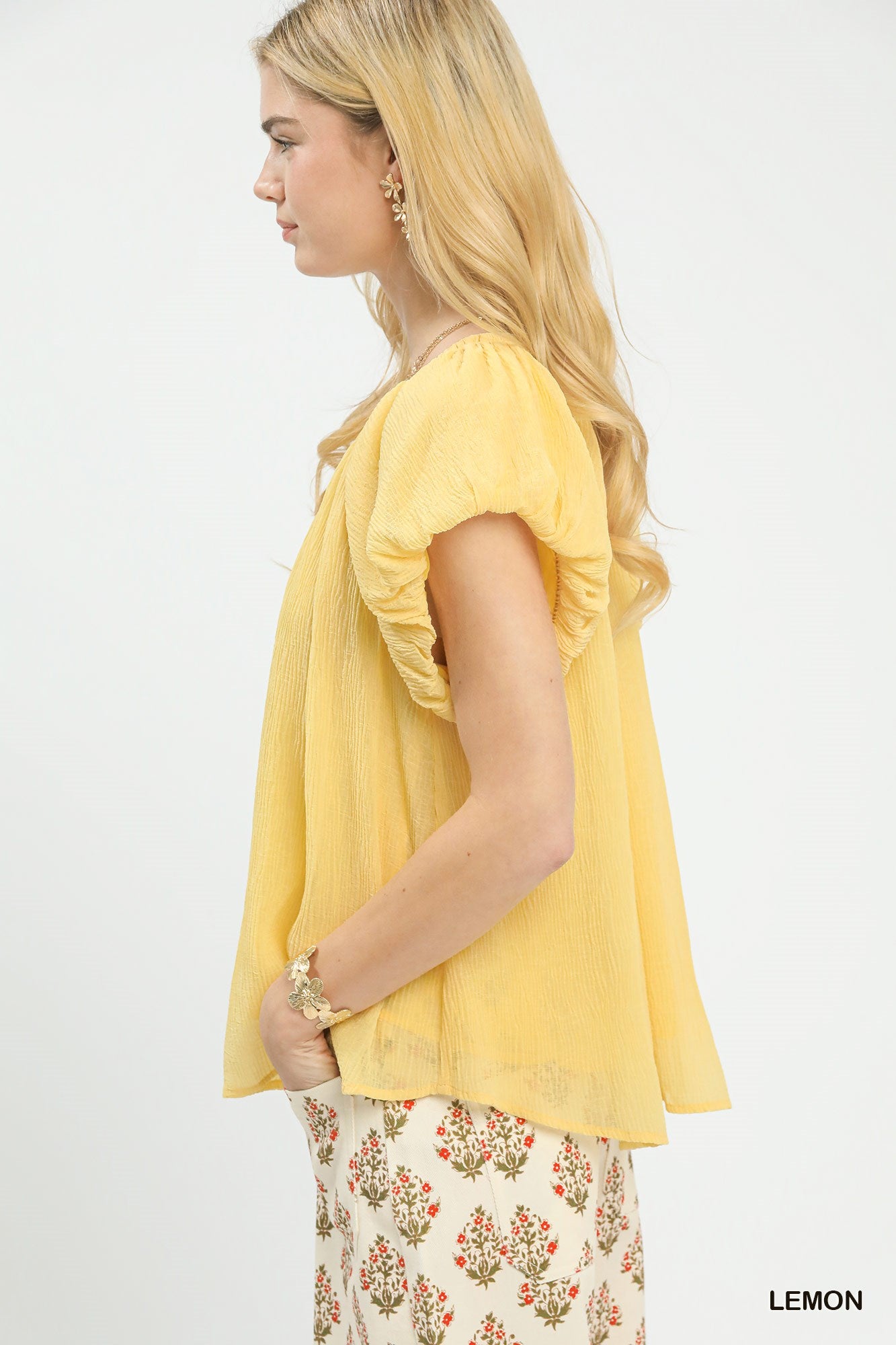 Women's crinkle fabric flutter sleeve peasant blouse in casual boho style, featuring relaxed fit and lightweight design.