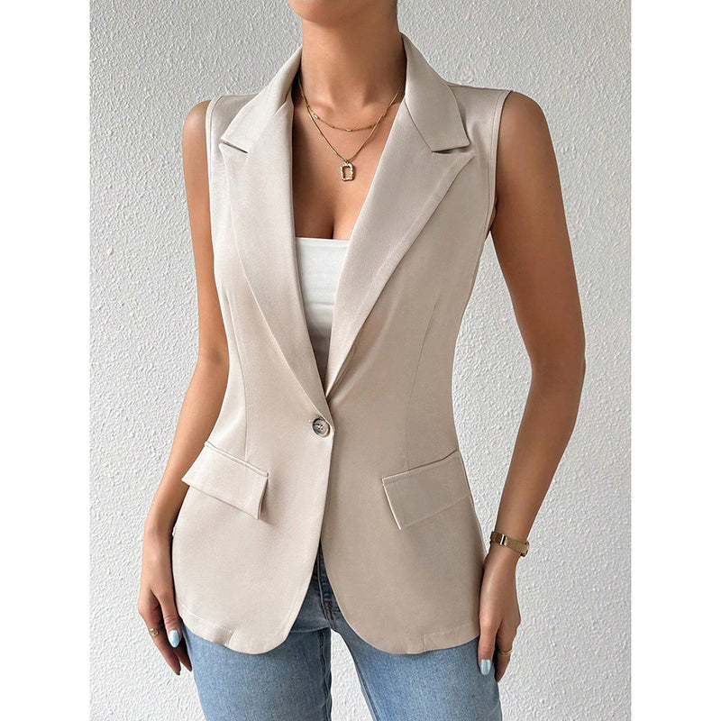 Beige sleeveless blazer with a notch lapel, single-button closure, and two flap pockets, worn over a white top.