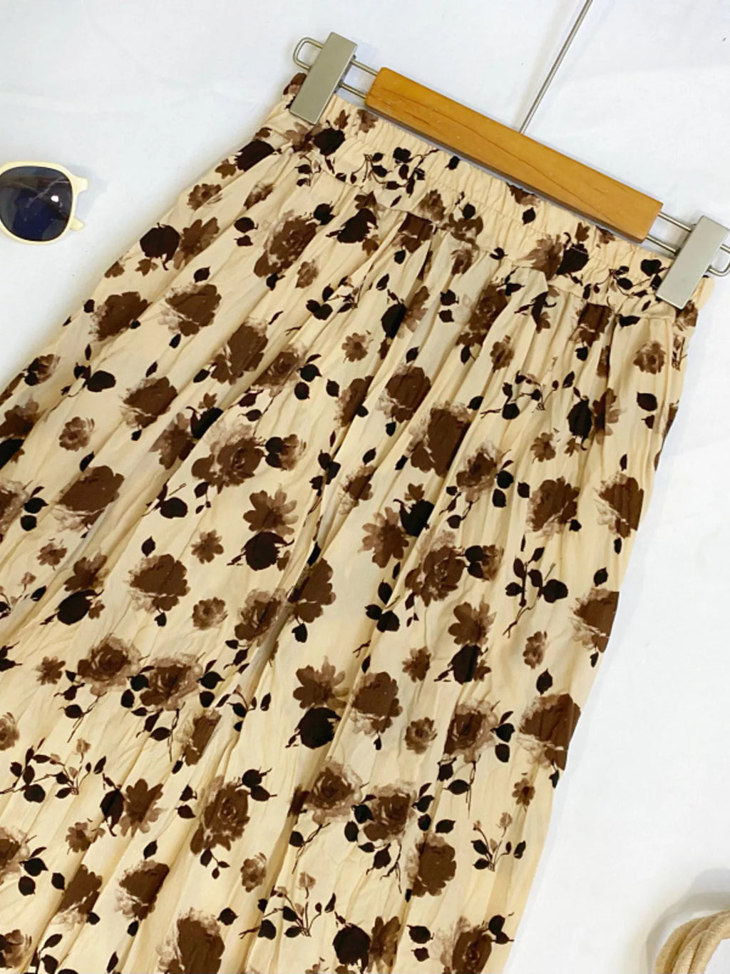 Floral print elastic waist midi skirt from Trendsi, featuring a flowy design and vibrant floral pattern.