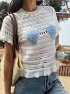 Openwork ruffled hem knit top by Trendsi featuring a breathable openwork design and feminine ruffled hem detail.