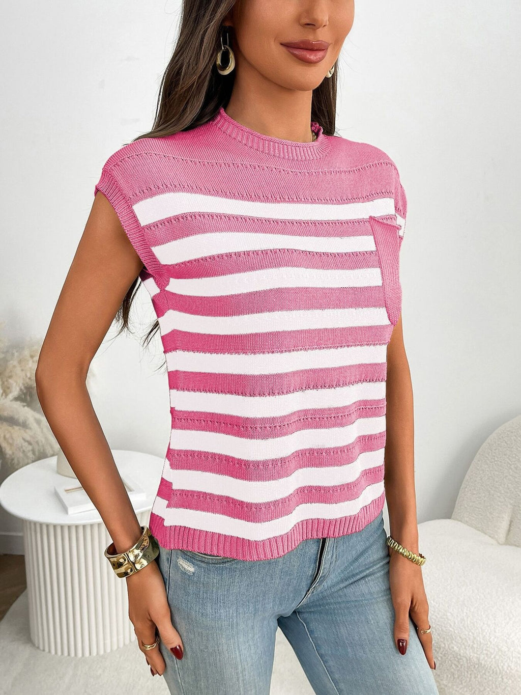 Women's striped knit cap sleeve sweater with pocket detail, trendy and casual, perfect for cool weather.