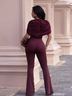 Rust-colored ruched flare leg jumpsuit from Trendsi, featuring a fitted bodice and wide, flowing legs.