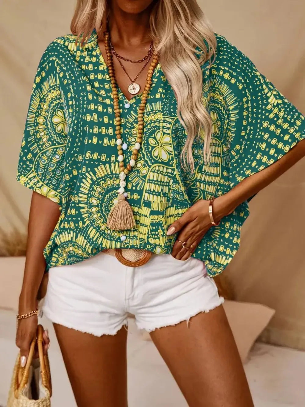 Women's printed V-neck half sleeve casual top from Trendsi, soft stretch fabric, perfect for office or casual wear.