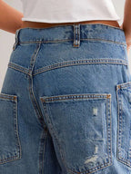 Distressed Plush Fashion Shop denim jeans with front and back pockets, featuring a trendy ripped and faded design.