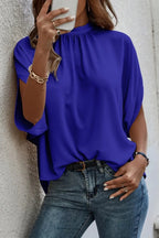 Elegant Trendsi tie-back half-sleeve blouse with side slit, lightweight fabric, and stylish design, perfect for casual or dressy wear.