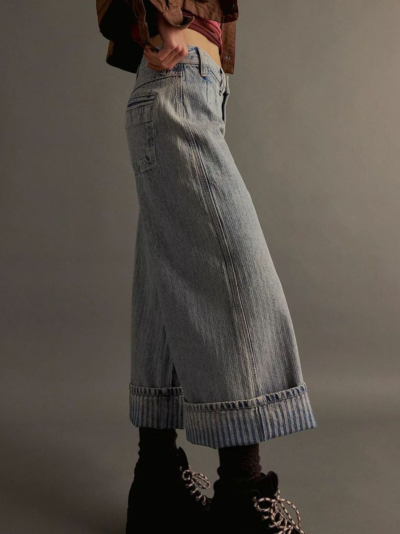 Light blue plush fashion shop denim wide-leg cropped jeans displayed on a hanger with visible stitching and relaxed fit.