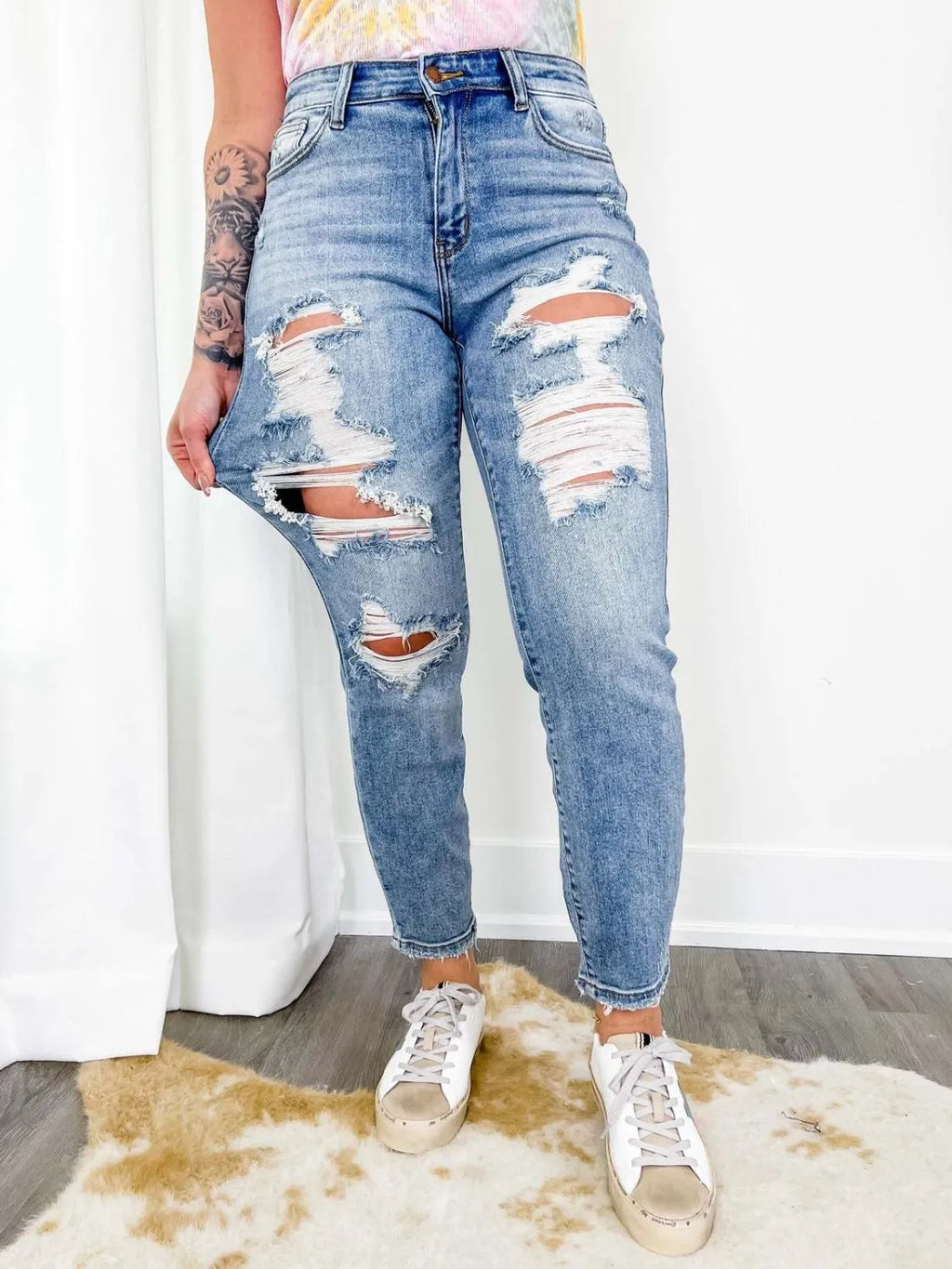 Distressed skinny jeans from Trendsi showing ripped details and fitted silhouette in a casual denim style.