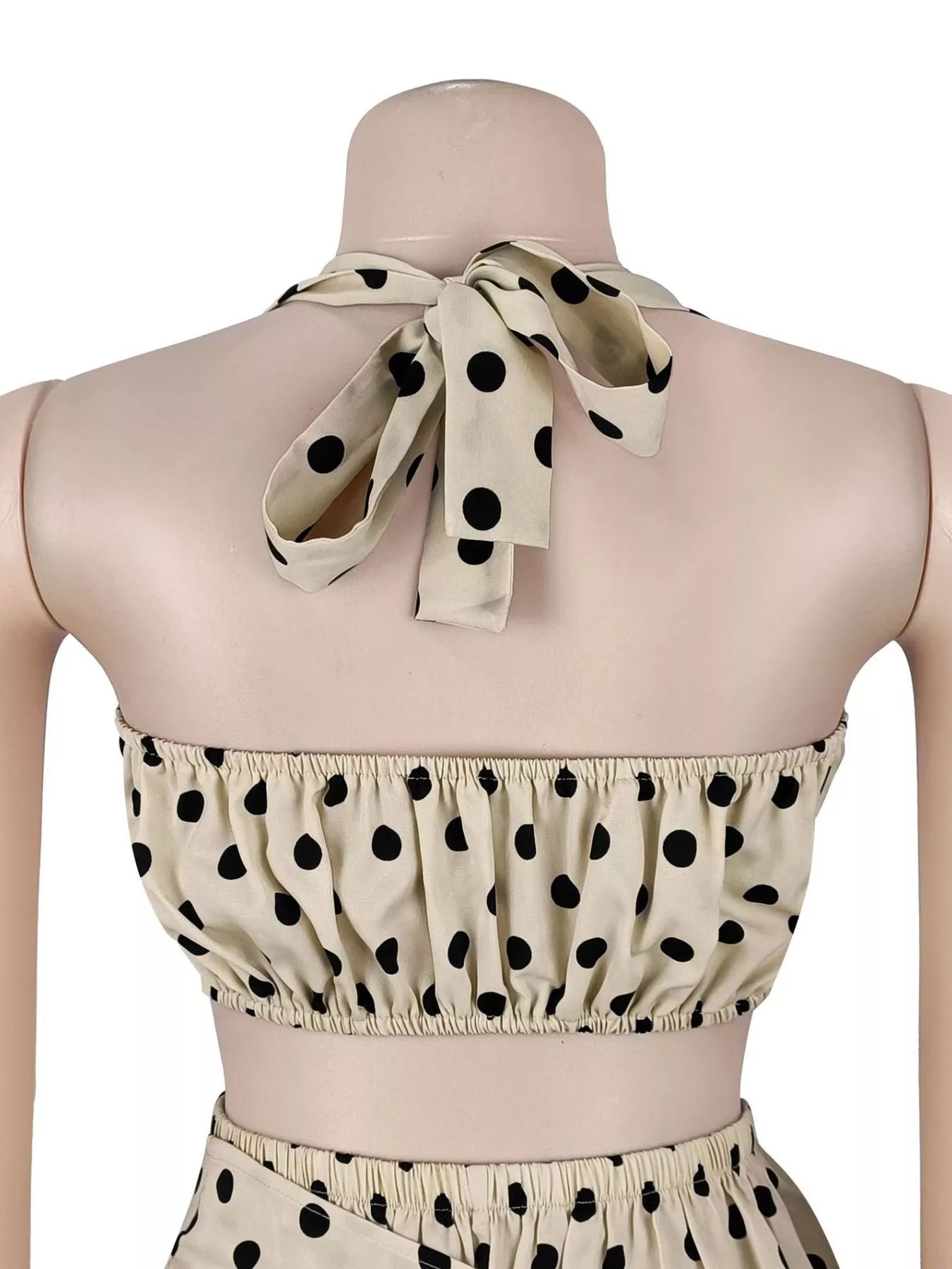 Polka dot halter neck cami with fringe trim pants set by Trendsi, featuring a stylish polka dot pattern and coordinated matching pieces.