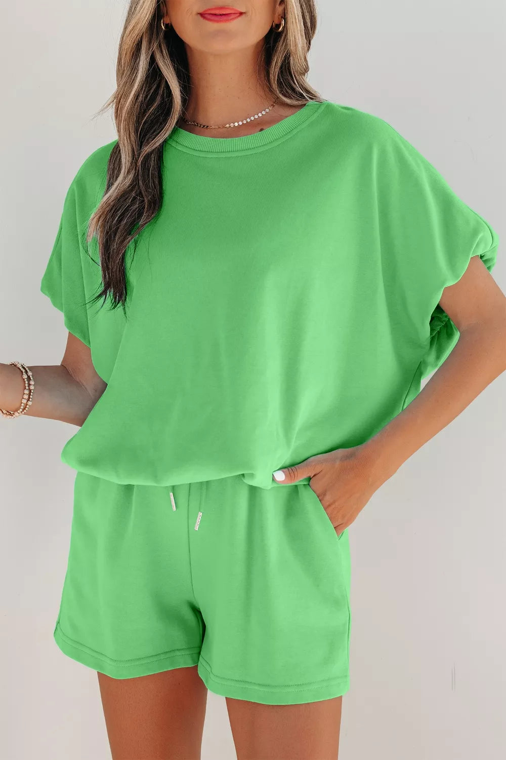 Solid color puffy loose top and drawstring shorts set from Trendsi, casual 2-piece outfit with comfortable fit and relaxed style.