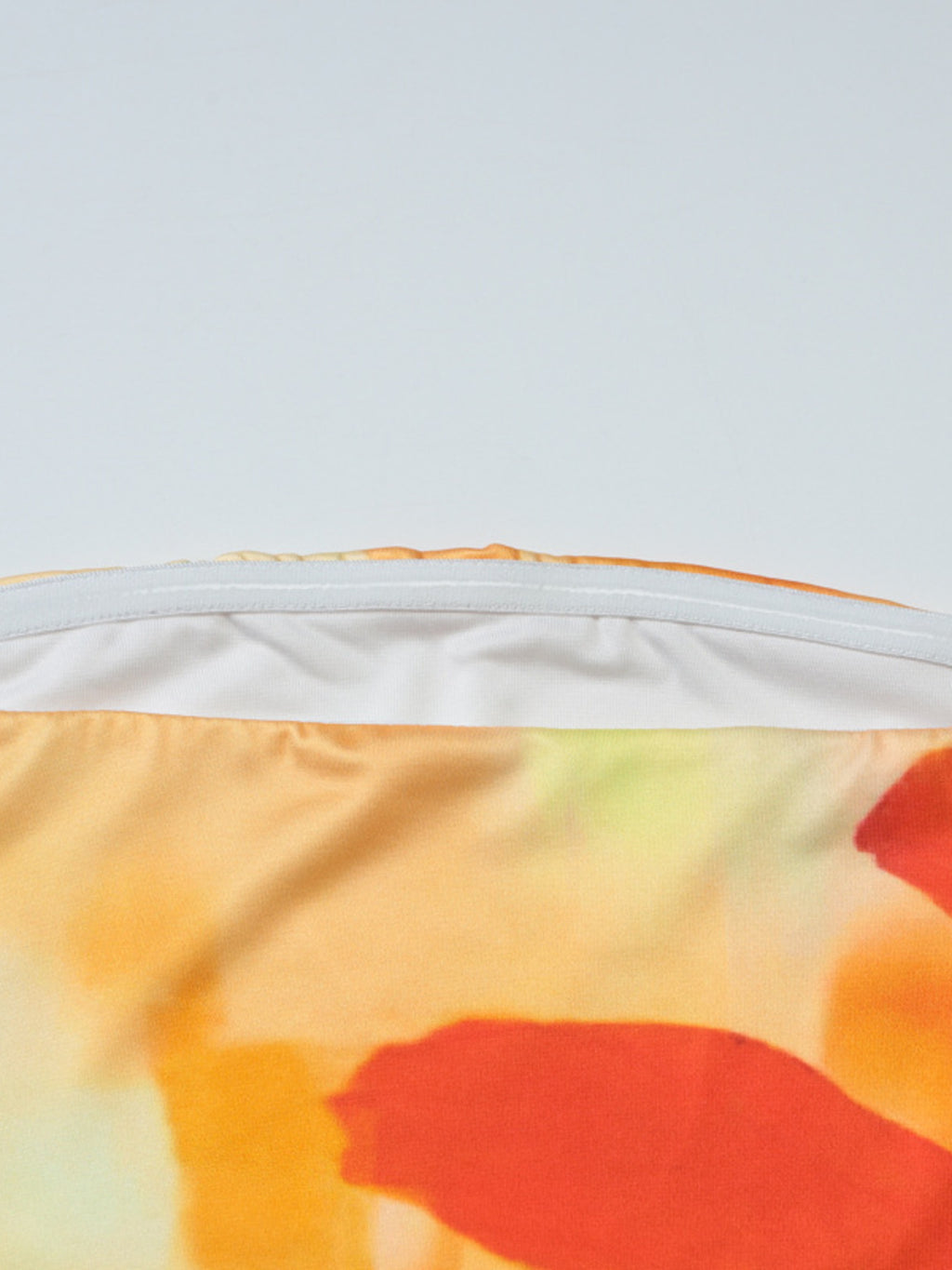 Women's floral print strapless tube top by Trendsi, summer bandeau crop top with vibrant floral design and fitted style.
