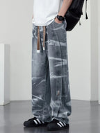 Men's plus size washed wide-leg jeans by Trendsi, showing a relaxed fit with distressed details and classic denim texture.