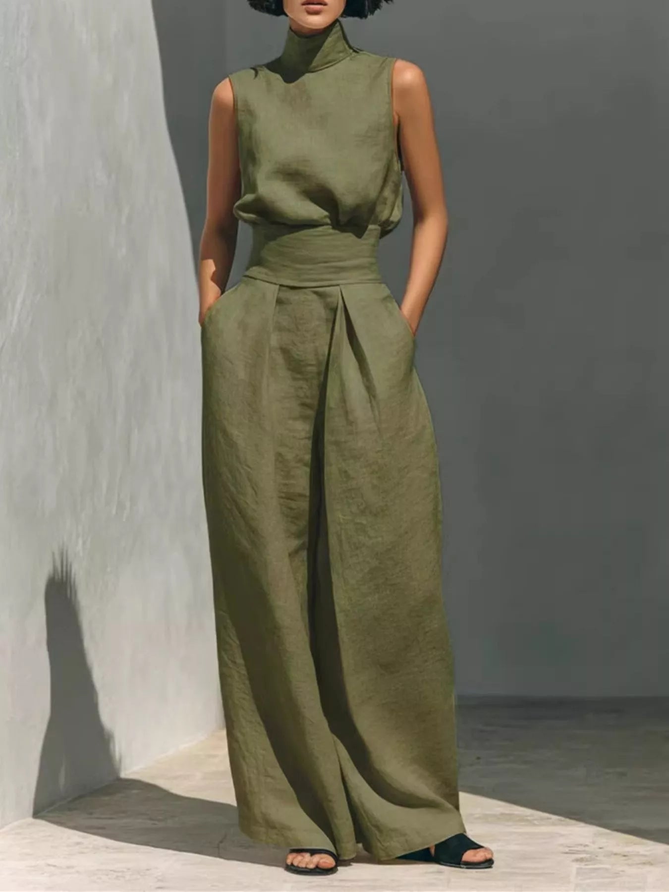 Sleeveless turtleneck top and wide-leg pants set by Trendsi, shown in a stylish, coordinated outfit with a modern silhouette.