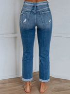 Distressed denim jeans with front and back pockets from Trendsi, showcasing a casual, worn-in style.