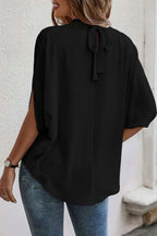 Trendsi elegant tie-back half-sleeve blouse with side slit, featuring a stylish design and soft fabric for a chic look.