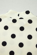 Polka dot print high neck dolman top by Trendsi, featuring a relaxed fit and stylish design, shown in a close-up image.