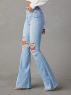 Distressed jeans with front and back pockets from Trendsi, featuring a ripped, casual denim style.