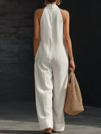 Halter neck wide-leg jumpsuit by Trendsi featuring a stylish halter top and flowy wide-leg pants in a sleek design.