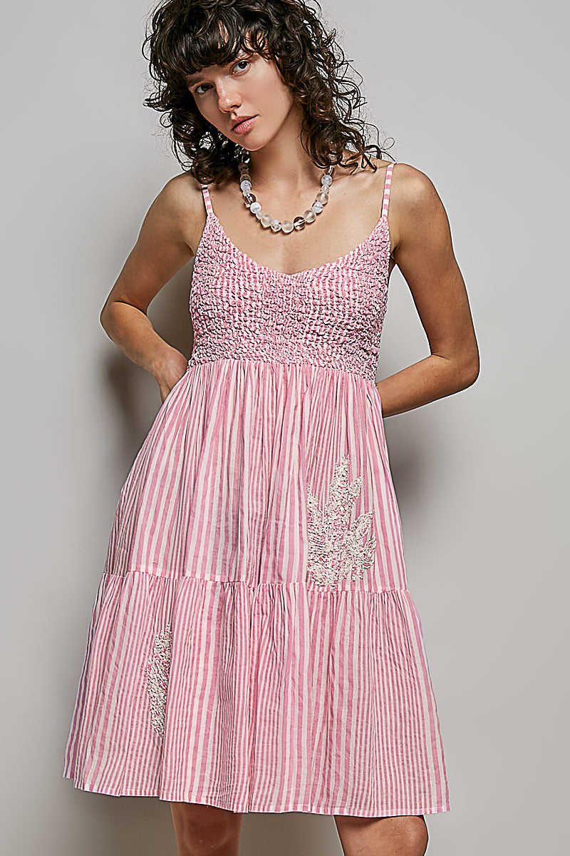 Women's sleeveless striped smocked embroidered cotton mini dress with a fitted bodice and flared skirt, casual summer style.