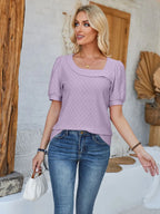 Black eyelet asymmetrical neck short sleeve T-shirt from Trendsi featuring unique neckline and casual fit.