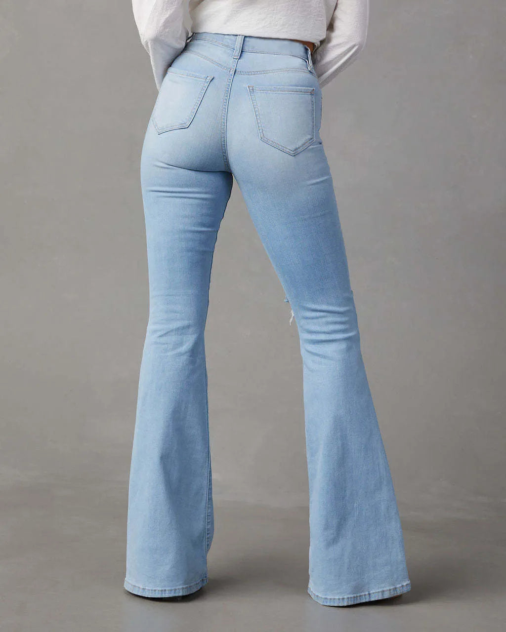 Distressed jeans with pockets from Trendsi, showing a casual fit with ripped details and functional front and back pockets.