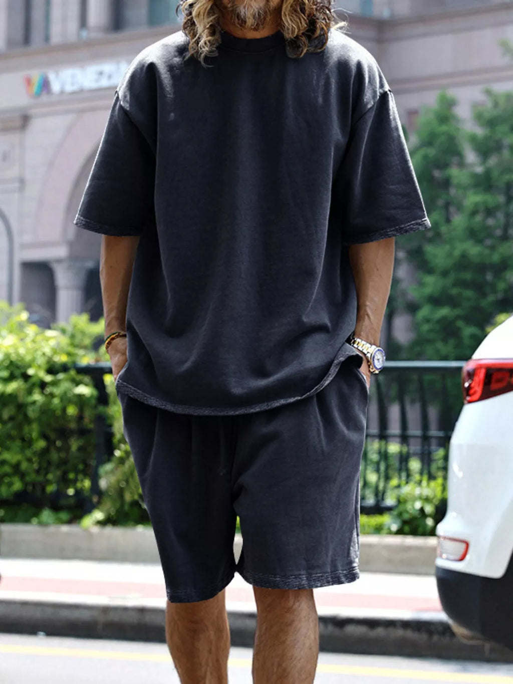 Men's relaxed fit T-shirt and shorts set in plus size by Trendsi, featuring comfortable casual style and breathable fabric.