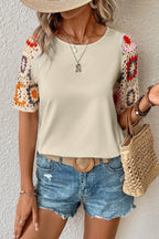 Geometric print round neck short sleeve blouse from Trendsi, featuring a stylish pattern and comfortable fit.
