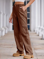High-waisted cargo denim jeans by Plush Fashion Shop featuring multiple pockets and a relaxed fit on a model.
