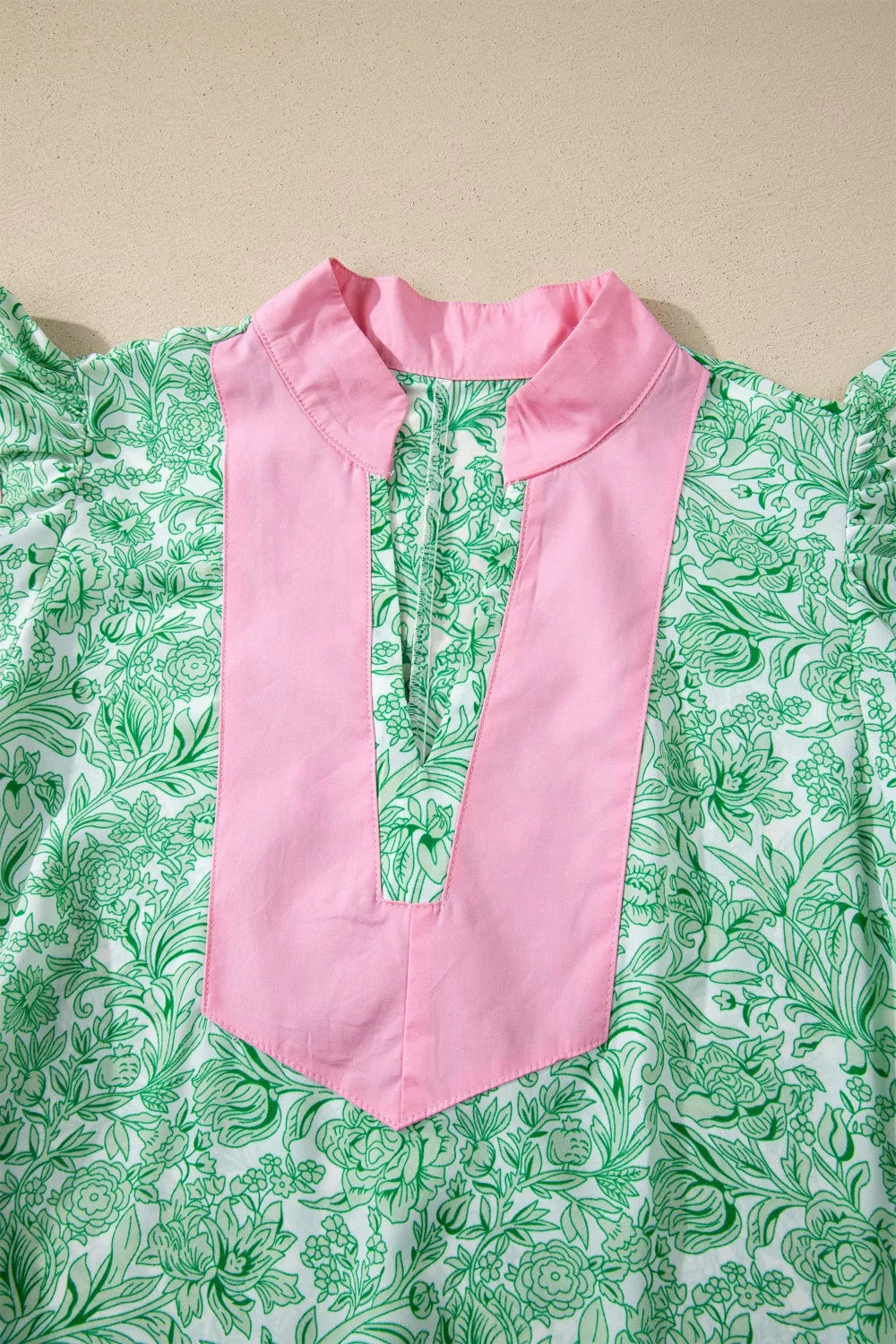 Floral midi dress by Trendsi featuring contrast trim, flutter sleeves, and a flowy design perfect for warm weather.