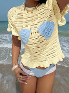 Openwork ruffled hem knit top from Trendsi featuring a detailed open-knit pattern and a stylish ruffled hem.