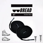 Sparkly black elastic shoelace from Bread's Shadow Black collection, featuring a shiny, flexible design for comfortable fit.