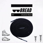 Black elastic shoelace by Bread, shown in classic style with aglets and flexible material for easy slip-on fit.