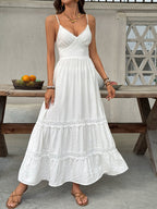 Women's V-neck tiered maxi dress with delicate lace detail, flowing fabric, and elegant design.
