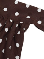 Polka dot halter neck mini dress by Trendsi featuring a fitted silhouette and stylish design, shown on a model.